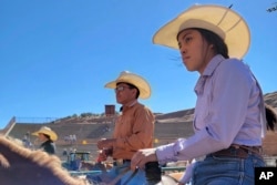 In this undated photo provided by Tyrone Tsosie, his children Tydon and Tyra Tsosie compete in a rodeo event in Gallup, N.M.