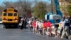 FILE - Students are taken to a reunification site after a deadly shooting at their school in Nashville, Tennessee, March 27, 2023. The United States is setting a record pace for mass killings in 2023, with an average of one every 6.53 days, according to a data analysis.