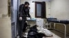 Men stand over the bodies of two victims who were killed in the aftermath of reported bombardment by Syrian government forces, at a hospital in the rebel-held city of Idlib in northwestern Syria, Dec. 30, 2023. 