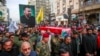 People walk in a funeral procession for Iranian senior commander General Razi Mousavi, in Najaf, Iraq, Dec. 27, 2023, ahead of the transfer of his body to Iran for burial. Mousavi was killed in an Israeli airstrike Monday near Damascus, Syria.