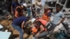 Palestinians search for survivors after an Israeli airstrike on a residential building in Nuseirat Refugee Camp, Gaza Strip, May 19, 2024. 