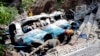 Rescue workers look for the victims and wounded passengers from the wreckage of a bus that fell into a ravine, near Kahuta, Pakistan, Aug. 25, 2024. 