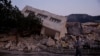 FILE - A man walks by rubble in the aftermath of an earthquake in Antakya, Turkey, on Feb. 21, 2023. Nearly a year after two earthquakes killed more than 50,000 people, Turkey began the first major trial linked to building construction that may have contributed to the deaths.