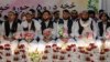 Afghan grooms look on during a mass wedding ceremony at a wedding hall in Kabul, Dec. 25, 2023. 