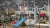 Residents walk past debris in the aftermath of Hurricane Otis in Acapulco, Mexico, Oct. 27, 2023.