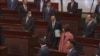 In this image from video taken Oct. 25, 2023, and released by Hong Kong Legislative Council, Hong Kong Chief Executive John Lee enters the Legislative Council meeting room to deliver a policy address. (Hong Kong Legislative Council Pool via AP)