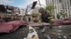A sapper inspects fragments of a Russian air bomb that hit a living area in Kharkiv, Ukraine, May 22, 2024.