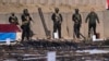 FILE - The Popular Mobilization Forces display weapons seized from Islamic State militants in Salahuddin province, north of Baghdad, Iraq, Jan 12, 2023. The IS claimed responsibility Sunday for the killing in the province of two pro-Iran fighters.