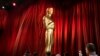 Workers move an Oscar statue during preparations for Sunday's 95th Academy Awards, March 11, 2023, in Los Angeles. 