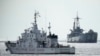 Philippine coast guard patrol vessel BRP Malapascua, left, goes near the Philippine navy ship BRP Sierra Madre at the Second Thomas Shoal, at the South China Sea, April 23, 2023.