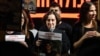 Former Russian-Israeli hostage Yelena Tropanov, center, holds a picture of her 27-year-old son Alexander (Sasha) Tropanov during a demonstration in Tel Aviv on Dec. 2, 2023, calling for the release of hostages held in Gaza since the October 7 attacks.