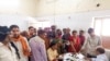 People crowd a hospital desk in Ballia district, in northern Uttar Pradesh state, India, June 18, 2023.