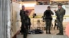 Military personnel stand guard at the entrance of a gymnasium while police investigators look for evidence after a bomb attack at Mindanao State University in Marawi, Lanao del sur province, Philippines, Dec. 3, 2023. 