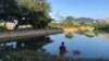 This photo taken Nov. 7, 2023, shows a man watching smoke rising from the direction of a Myanmar military base in Lashio township, northern Shan state. 
