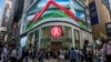 FILE - Pedestrians walk past a Hang Seng branch in Hong Kong, Oct. 28, 2022. Ratings agency Moody's downgraded the outlook on Hong Kong's credit rating to negative from stable, Dec. 6,2023, following a similar change for China the day before.