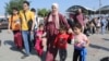 Palestinians cross to the Egyptian side of the border crossing with the Gaza Strip in Rafah, Nov. 1, 2023.