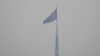 FILE - A North Korean flag flutters in the wind atop a tower in North Korea's village Gijungdong as seen from an observation post inside the demilitarized zone in Paju, South Korea, Feb. 7, 2023.