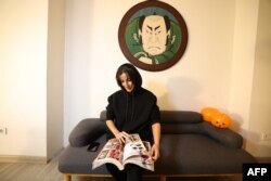 A customer looks through designs at a tattoo studio in Tehran, Iran, on Nov. 7 2023.