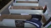 FILE - Mock coffins with photos of Palestinian journalists killed during the current war in Gaza are prepared by fellow journalists for a symbolic funeral march toward a United Nations office in the West Bank city of Ramallah, Nov. 7, 2023.