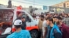 People gather around an ambulance damaged in a reported Israeli strike in front of Al-Shifa hospital in Gaza City on Nov. 3, 2023.
