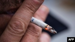 This picture taken shows a man as he smokes a cigarette in Sundbyberg, near Stockholm, Oct. 31, 2023. Sweden is poised to soon become Europe's first smoke-free country largely thanks to the popularity of snus. 