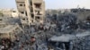 People check the damage caused by an Israeli strike on the Al-Maghazi refugee camp in Deir Balah in the central Gaza Strip, on Nov. 5, 2023.
