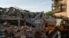 A tractor clears the rubble after a Russian strike on the Sapphire hotel in Kramatorsk, Donetsk region, Ukraine, Aug. 25, 2024. 