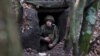 A Ukrainian serviceman looks out from an underground shelter on the frontline near the town of Bakhmut, Donetsk region, on November 18, 2023, amid the Russian invasion of Ukraine. 