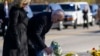 US President Joe Biden and first lady Jill Biden lay flowers at Schemengees Bar & Grille, one of the sites of last week's mass shooting, Nov. 3, 2023, in Lewiston, Maine. 