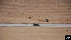 FILE - Syrian forces take up positions in their fight against Islamic State militants near the ancient city of Palmyra, Syria, March 2, 2017. Fourteen government soldiers reportedly were killed in the area by IS militants on Jan. 9, 2024. (SANA via AP)