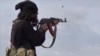 FILE - This image posted March 18, 2019, by the Amaq news agency shows an Islamic State fighter shooting at Syrian Democratic Forces in Baghouz, Syria. IS said on Nov. 10, 2023, that it had attacked pro-government forces in Syria in preceding days.