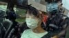 FILE - Agnes Chow, a prominent pro-democracy activist who was sentenced to 10 months in jail in November 2020 over an unauthorized assembly charge, is released, in Hong Kong, June 12, 2021. 
