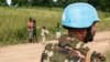 Children look at an United Nations (UN) Bangladeshi soldier part of MINUSCA (United Nations Multidimensional Integrated Stabilization Mission in the Central African Republic) on the road to Koui, Central African Republic, on Sept. 24, 2020.