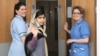 This photo made available by Queen Elizabeth Hospital shows Malala Yousafzai saying goodbye as she is discharged from the hospital to continue her rehabilitation at her family’s temporary home in the area, Jan. 4, 2013.