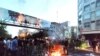 Demonstrators light a fire during a protest over the death of Mahsa Amini while in custody of Iran's "morality police," in Tehran, Sept. 21, 2022. (West Asia News Agency via Reuters)