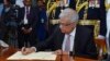 FILE - In this photo provided by Sri Lankan President's Office, Sri Lanka's newly elected president Ranil Wickremesinghe, signs after taking oath during his swearing-in ceremony in Colombo, Sri Lanka, July 21, 2022.