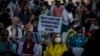 A demonstrator holds a placard during a protest against the suspension of sentences by the government for men convicted of gang raping a Muslim woman, in New Delhi, India, Aug. 27, 2022. 