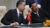 FILE - Chinese Foreign Minister Wang Yi, left, talks with Cambodian Prime Minister Hun Sen as they sit to witness a signing ceremony for a free trade agreement at Peace Palace in Phnom Penh, Cambodia, Monday, Oct. 12, 2020. (AP Photo/Heng Sinith)