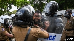 FILE - University students clash with police during a demonstration in Colombo, Sri Lanka.