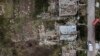 A crater from a Russian rocket attack Friday night is seen next to damaged homes in Kramatorsk, Donetsk region, eastern Ukraine, Aug. 13, 2022. The attack came less than a day after 11 other rockets were fired at the city, one of the two main Ukrainian-he