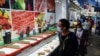 Customers wearing face masks walk past empty shelves at a wet market, ahead of mass coronavirus disease (COVID-19) testing, in Hong Kong, March 1, 2022. 