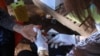 A Cambodian health agent pricks finger of an old lady who sought for HIV blood test service in Peam village, Muk Kompoul district, Kandal province, on Monday, Feb 22, 2016. (Photo: Aun Chhengpor/VOA Khmer)