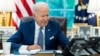 FILE - U.S. President Joe Biden speaks on the phone in the Oval Office of the White House in Washington, Sept. 22, 2021. (Adam Schultz/White House/handout via Reuters)