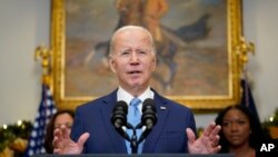 President Joe Biden speaks in the Roosevelt Room of the White House, Thursday, Dec. 8, 2022, in Washington. With the President from left, Vice President Kamala Harris and Cherelle Griner, Brittney Griner's wife.