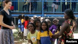 FILE - Australian aboriginal school children line-up to receive free laptop computers as part of the "One Laptop Per Child" program in Elcho, Island May 27, 2009. 