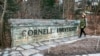 A woman walks by a Cornell University sign on the Ivy League school's campus in Ithaca, New York, Jan. 14, 2022. Cornell University administrators dispatched campus police to a Jewish center after threatening statements appeared on a discussion board, Oct. 29, 2023. 