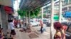 In this photo provided by the information office of Myanmar's military, four injured people can be seen lying on the pavement after an explosion at a bus stop in downtown Yangon on May 31, 2022. (Myanmar Military True News Information Team via AP)