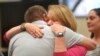 Plaintiffs Robbie Parker, left, and Nicole Hockley hug following the reading of the jury awards for damages in the Alex Jones defamation trial at Superior Court, Oct. 12, 2022, in Waterbury, Conn.