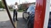 Bob Palrud of Spokane, Wash. speaks with a fellow electric vehicle owner who is charging up at a station along Interstate 90, on Wednesday Sept. 14, 2022, in Billings, Mont. Palrud says distances between EV charging stations are always on his mind during 