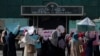 Afghan women hold placards as they take part in a protest in front of the Iranian embassy in Kabul, Sept. 29, 2022.